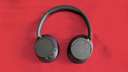 Sony WH-CH720N Noise Canceling Wireless Headphones on red fabric