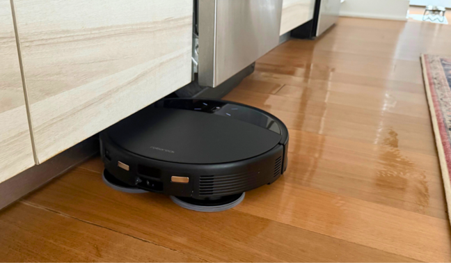 Roborock Saros 10R robot vacuum mopping hardwood kitchen floor under counter